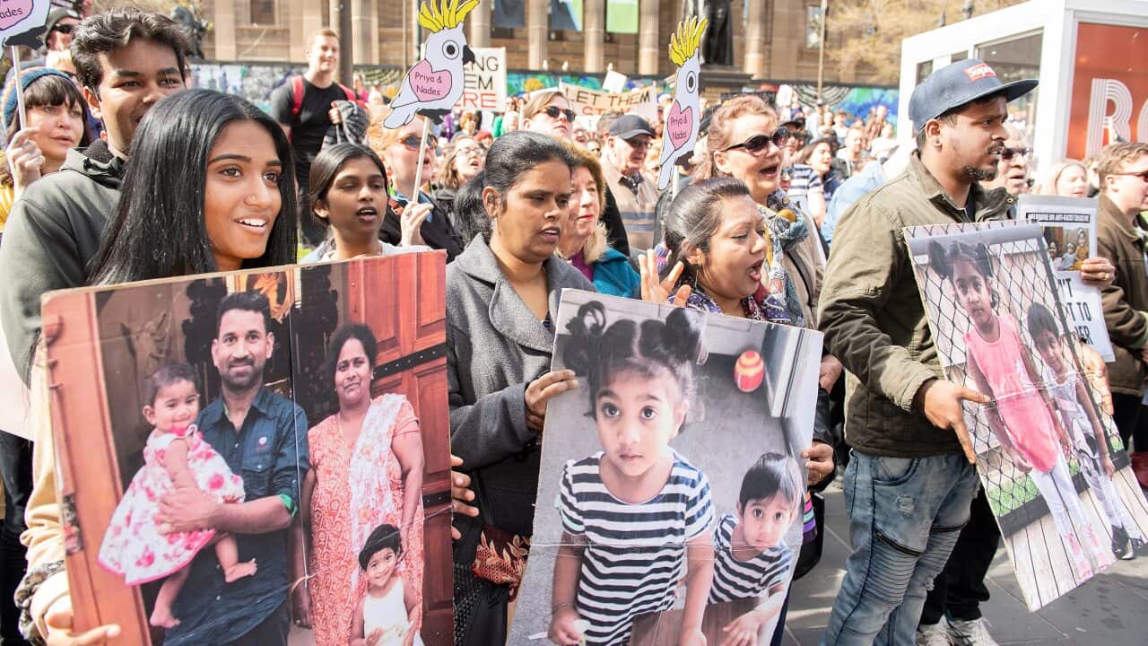 Supporters of Tamil asylum seekers Nadesalingam, Priya and their Australian-born children Kopika and Tharunicaa are seen at a rally outside the State Library of Victoria, Melbourne, Sunday, September 1, 2019. (AAP Image/Ellen Smith) NO ARCHIVING
