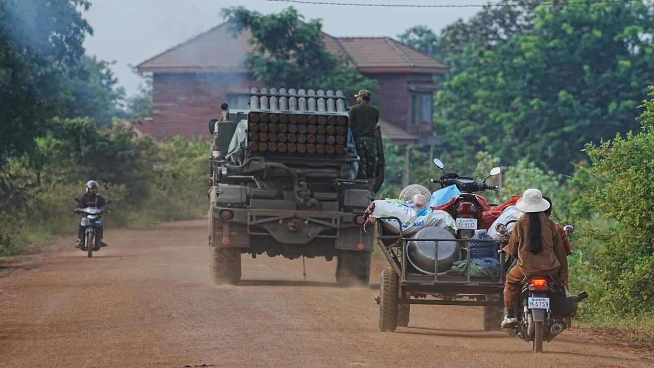 Cambodians drive behind a military vehicle for evacuation (AAP)