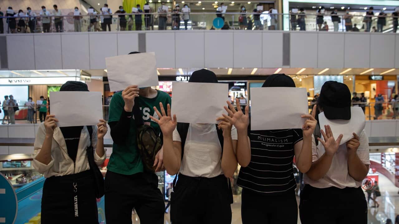Protesters display sheets of plain white paper during a protest in a shopping mall in Hong Kong on 6 July 2020. 