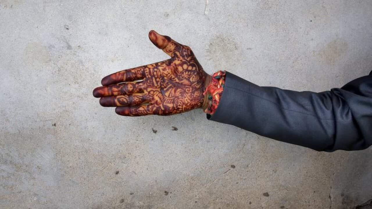 An Indian bridegroom's henna-decorated hand
