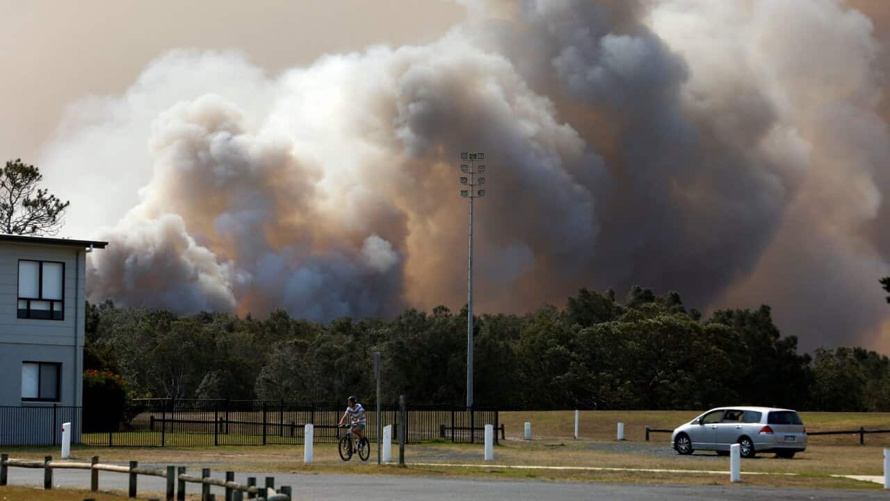 A bushfire burns out-of-control near houses at Old Bar, NSW, Saturday, November 9, 2019. Two people have been killed and seven others are missing in bushfires in NSW which have also destroyed at least 100 homes. (AAP Image/Darren Pateman) NO ARCHIVING