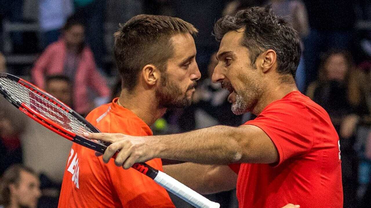 Viktor Troicki (L) and Nenad Zimonjic (R) of Serbia celebrate