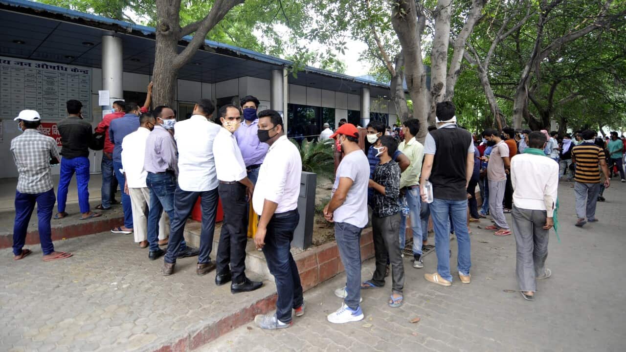 People queueing for a COVID-19 test in Noida, India