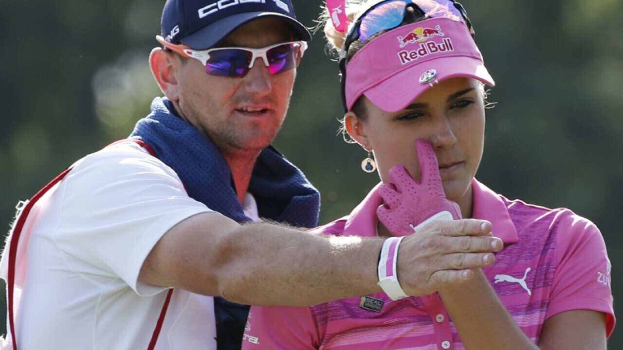 Lexi Thompson listens to her caddie, Kevin McAlpine