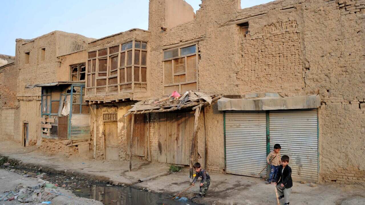 Afghan children play alongside a sewerage canal in the old part of Kabul Getty.jpg
