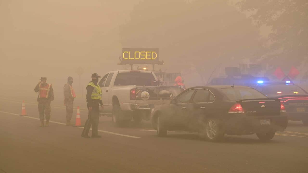 Vehicles travel through a checkpoint manned by Oregon state police