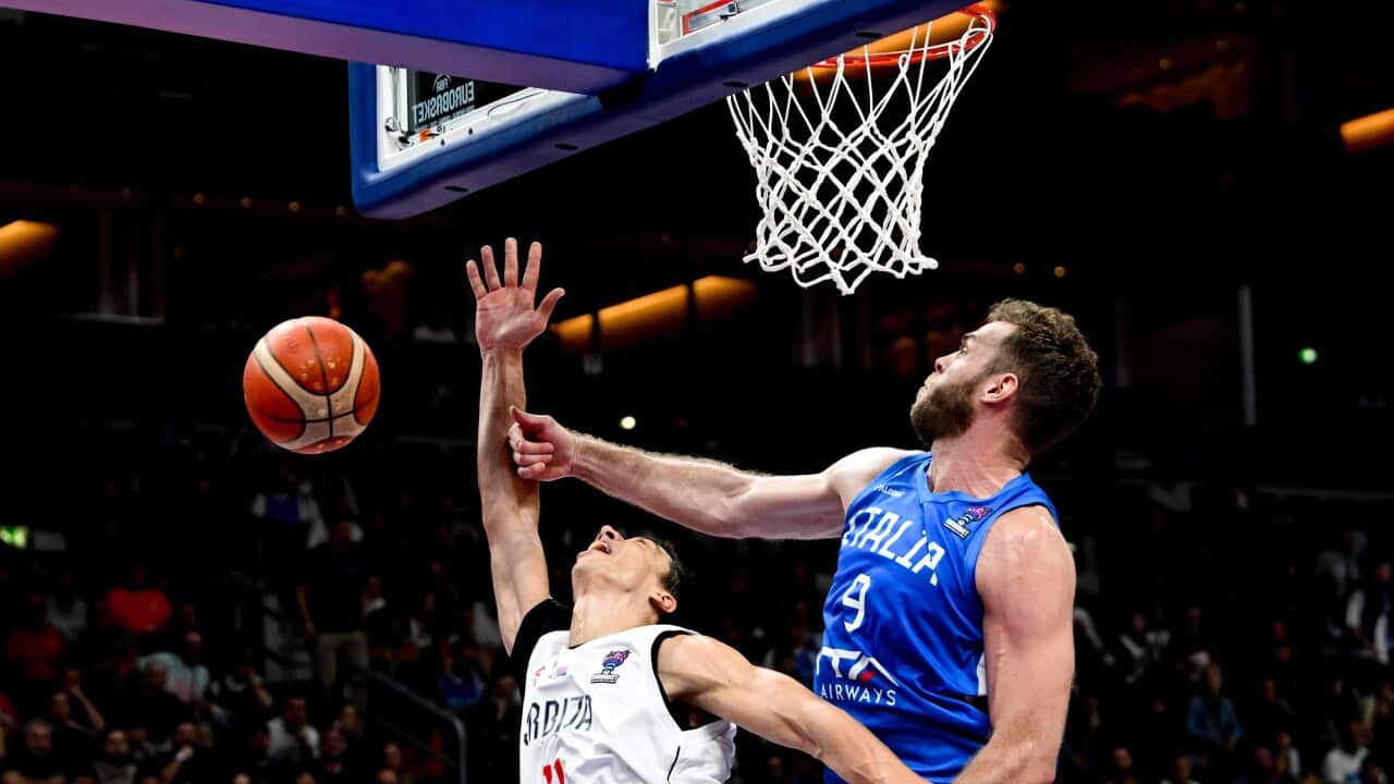 Serbia's Vladimir Lucic (L) in action against Nicolo Melli (R) of Italy during the FIBA EuroBasket 2022 round of 16 match between Serbia and Italy at EuroBasket Arena in Berlin