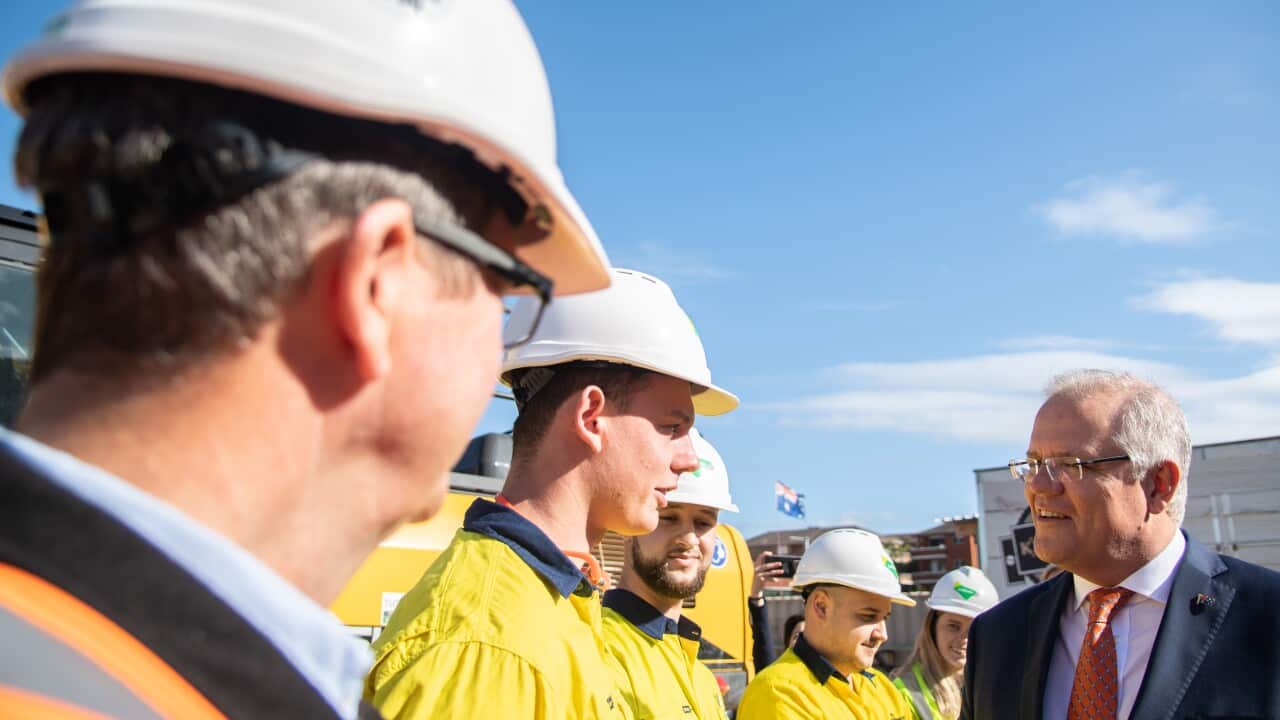 Prime Minister Scott Morrison talking with apprentices during a tour of a construction site