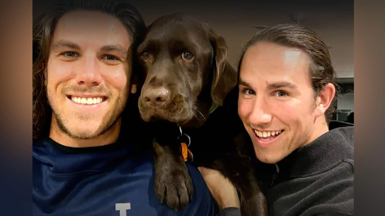 Two brothers with their dog.