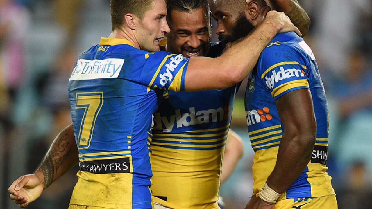 Semi Radradra of the Eels (R) is congratulated by teammates
