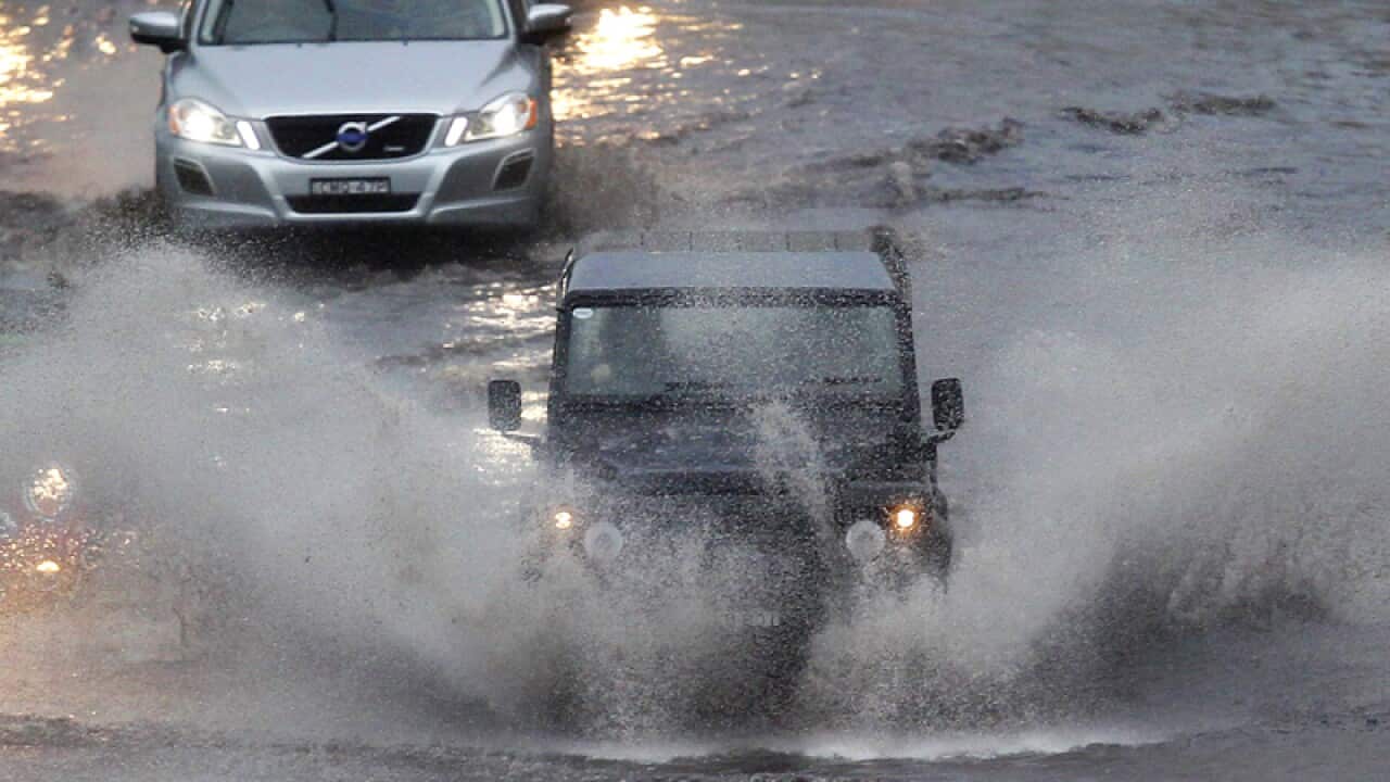 A vehicle sprays water as it powers its way through a road in Sydney