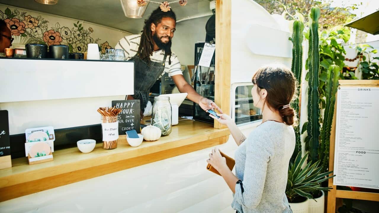 Man serving customer_GettyImages_ThomasBarwick