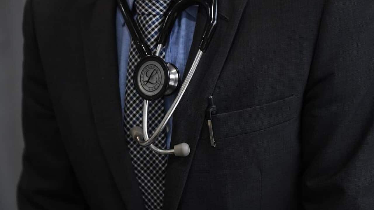 A medical doctor wears a stethoscope.