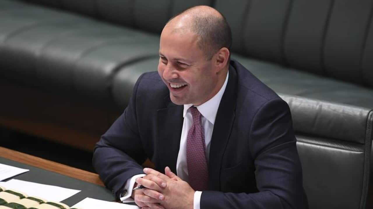 Josh Frydenberg laughs during a tax cuts debate in parliament.