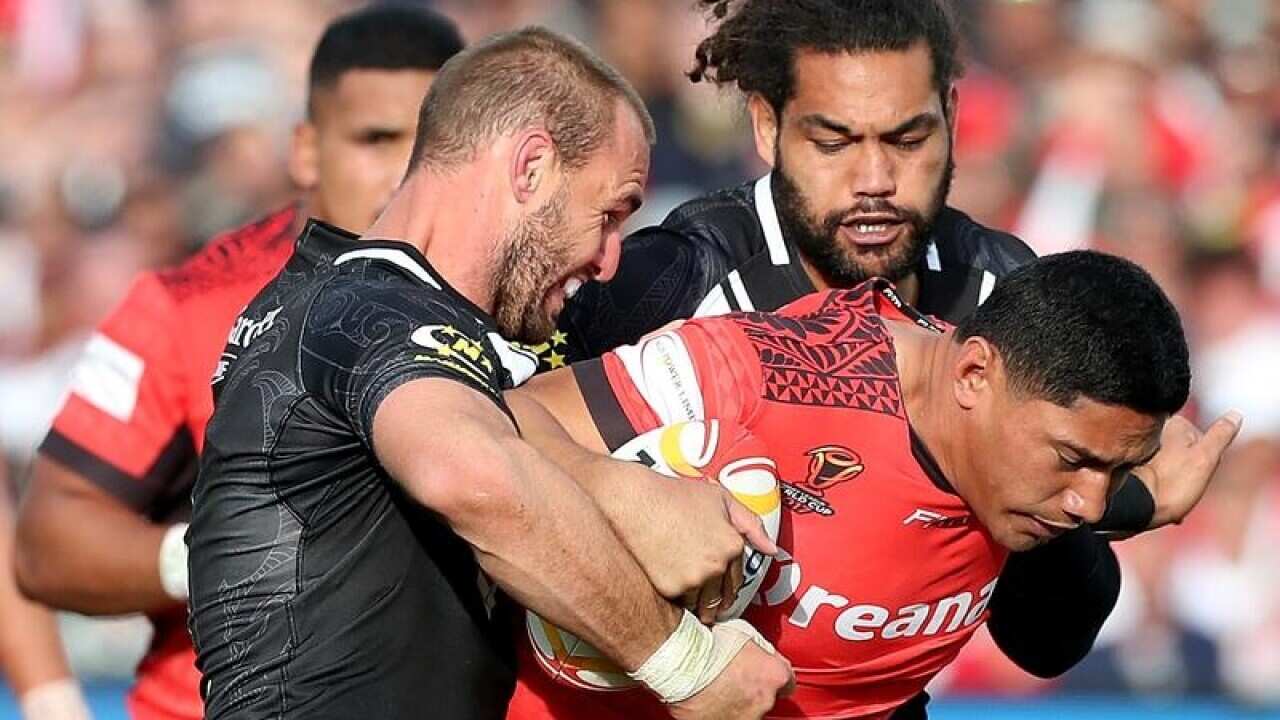 Jason Taumalolo (C) is tackled by Simon Mannering and Adam Blair