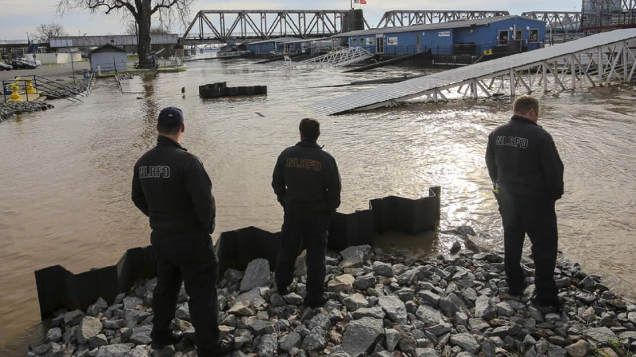 Firefighters look over the Arkansas River in Little Rock