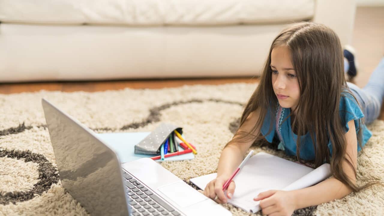 Girl attending online school classes from home