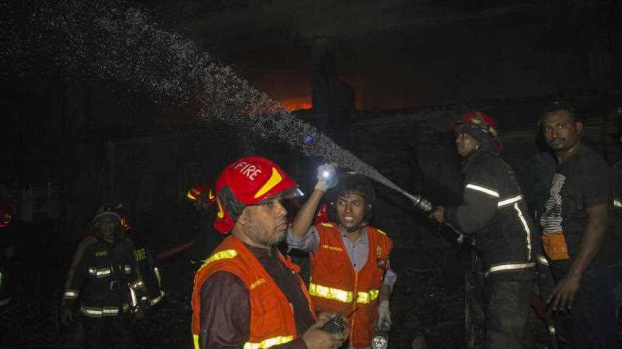 Bangladeshi firefighters and locals try to extinguish fire at Chawk bazar's Churihatta area, Old Dhaka.