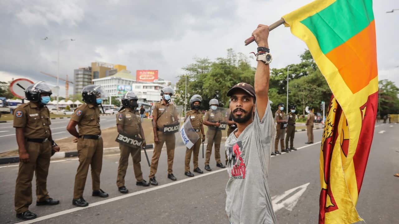 A man holds a Sri Lankan national flag during a protest,
