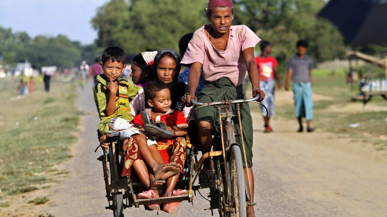 Bangali (also known as Rohingya) family members ride trishaw as they travel through Thet Kel Pyin Muslim refugee camp near Sittwe, Rakhine State, western Myanmar (AAP)