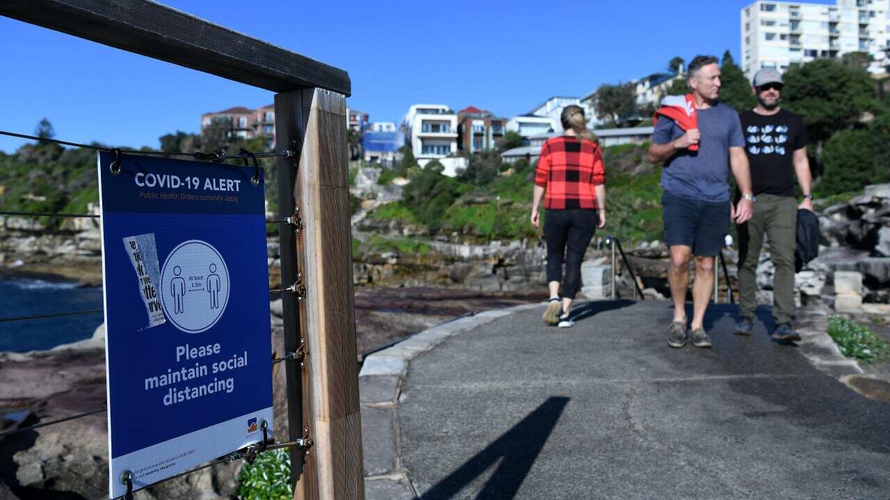Walkers exercise at Bondi Beach in Sydney.