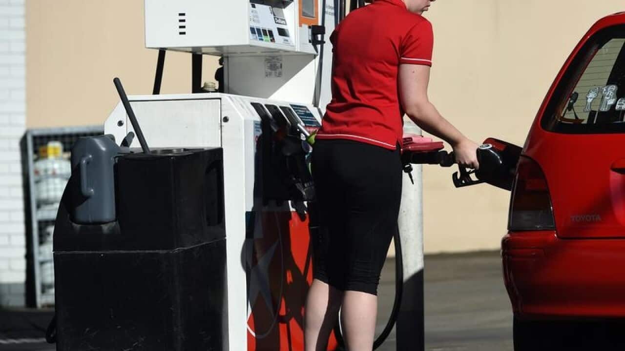 women filling car up at pump