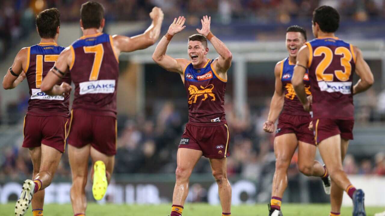 Brisbane Lions players celebrate against West Coast
