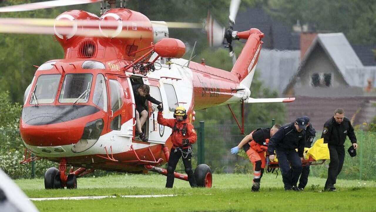 Rescuers transport storm victims in Poland