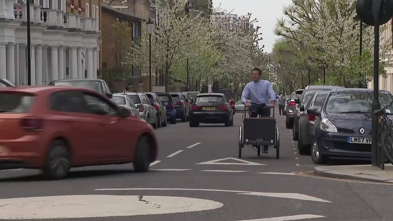 London vicar Pat Allerton sets off on his bike for his mobile church service