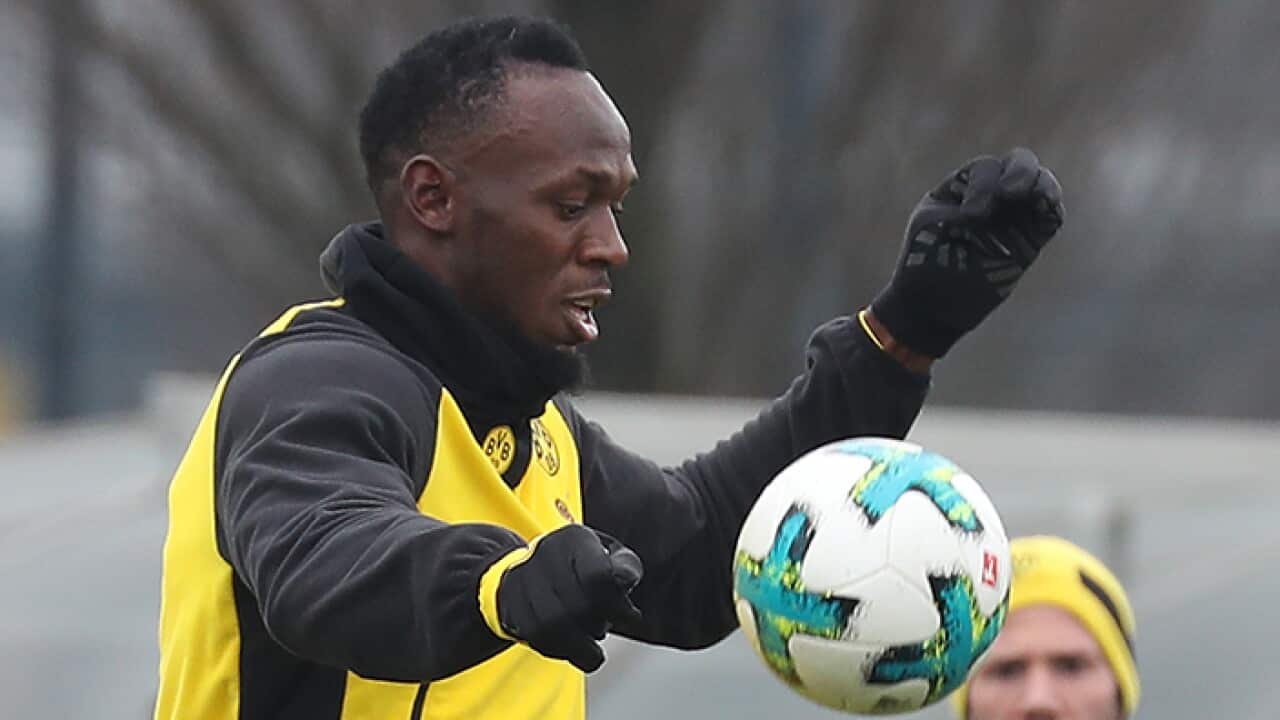 Usian Bolt plays football