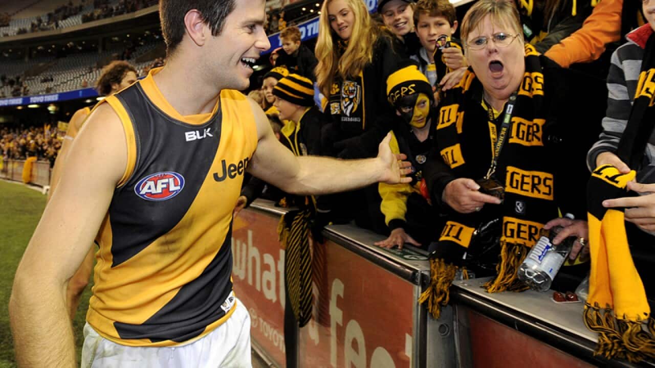 Richmond skipper Trent Cotchin greets crowds
