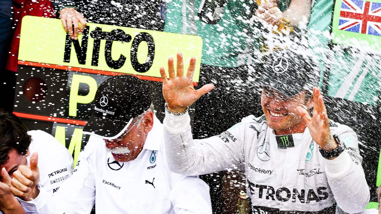 German Formula One driver Nico Rosberg (R) celebrates with Daimler AG CEO Dieter Zetsche (L) after winning the 2014 Formula One Grand Prix of Monaco. (EPA)