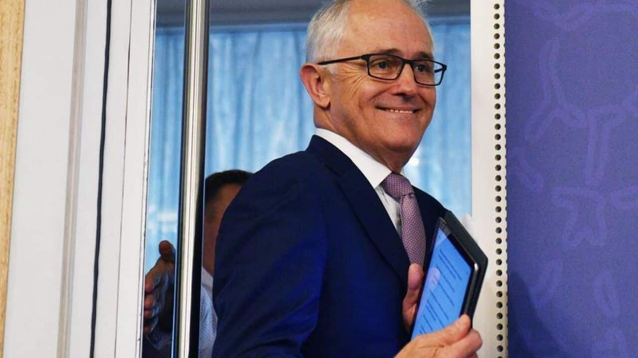 Prime Minister Malcolm Turnbull arrives at a press conference.