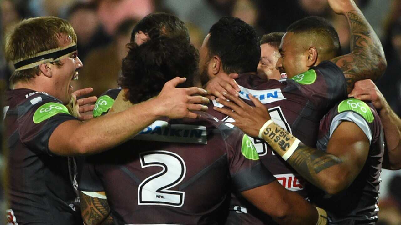 Manly players celebrate after scoring a goal
