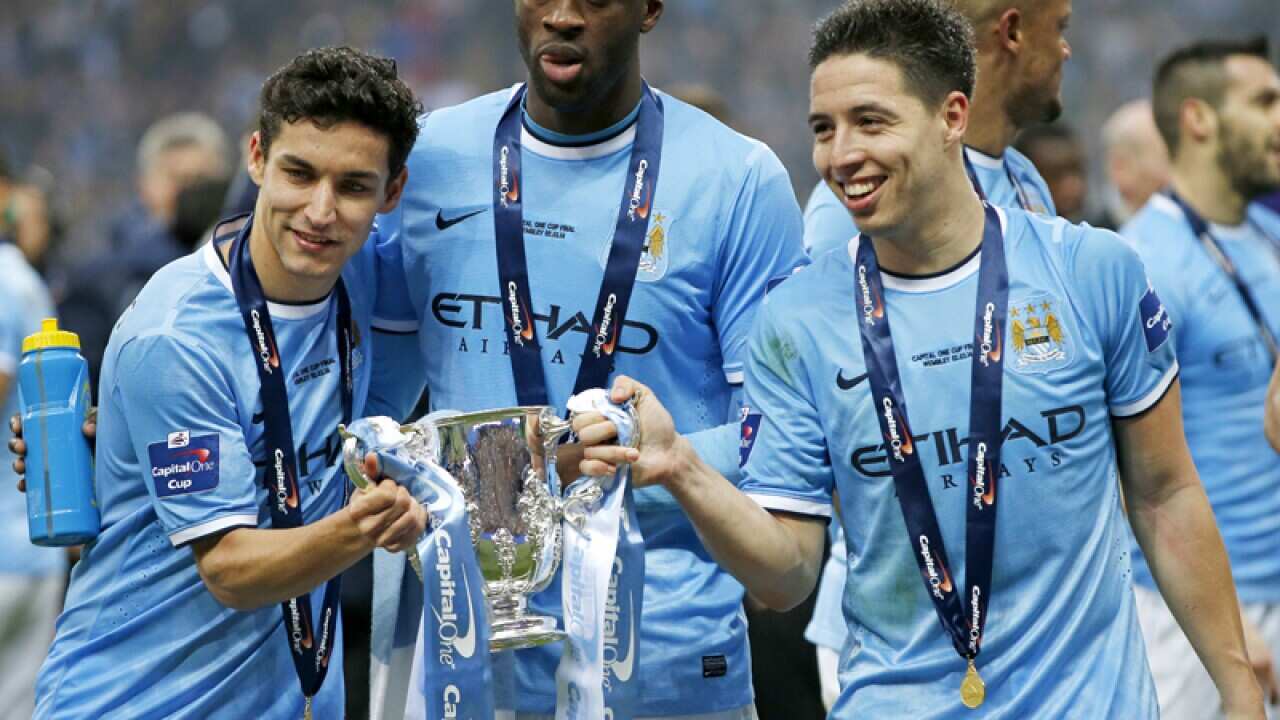 Manchester City's Jesus Navas (L), Yaya Toure (C) and Samir Nasri