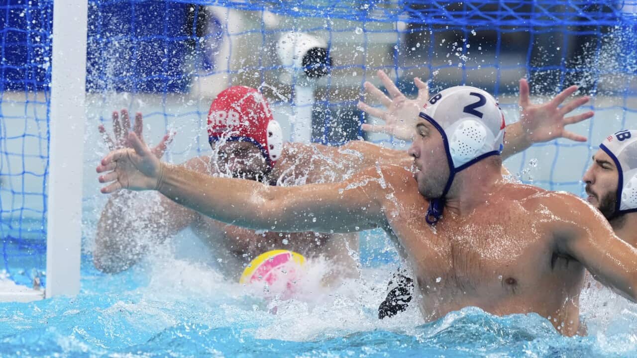 Serbia's goalkeeper Radoslav Filipovic and Dusan Mandic defending during a men's water polo semifinal match against Hungary in Singapore
