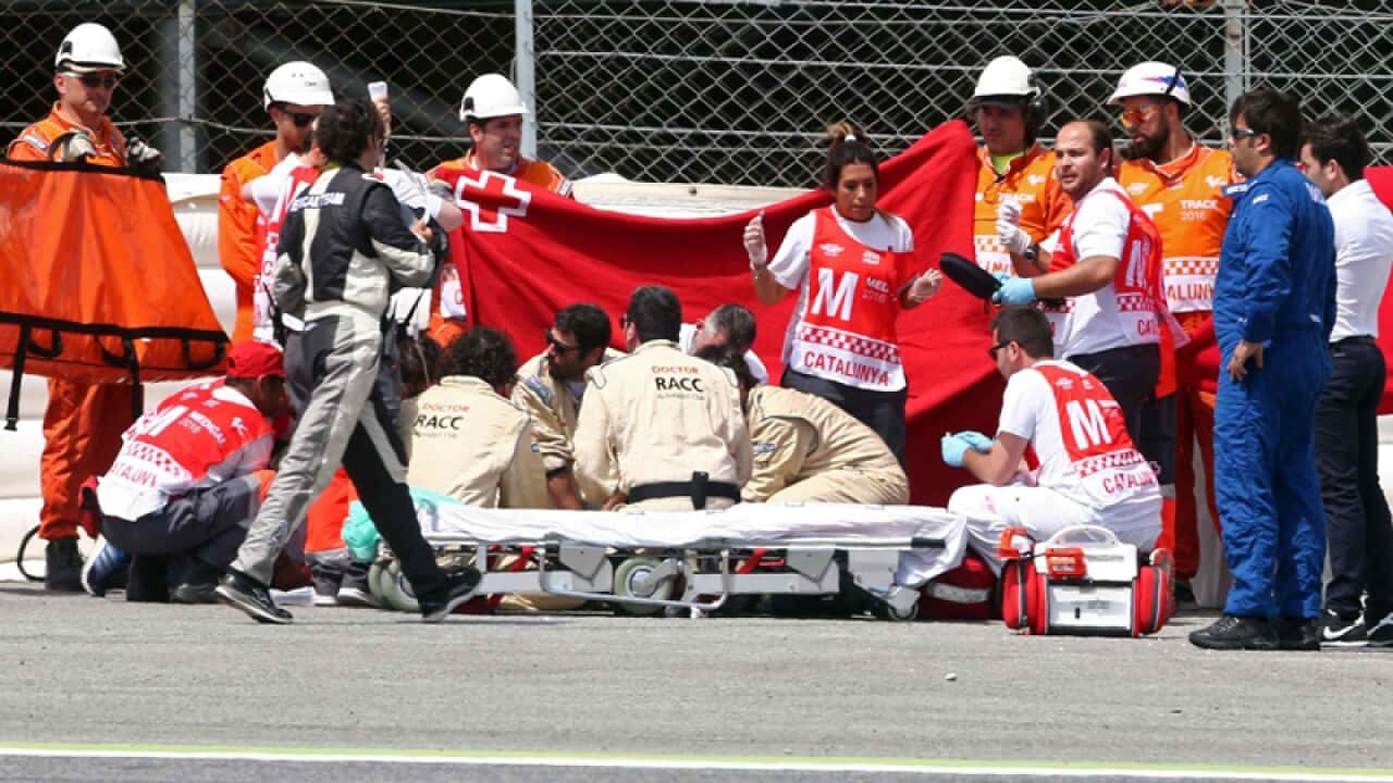 Medical assistance is given to Spanish MotoGP2 rider Luis Salom