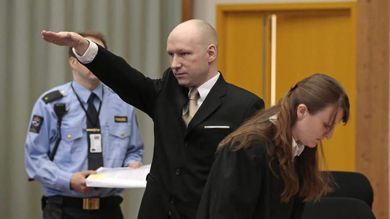 Anders Behring Breivik gestures as he enters a courtroom in Skien, Norway, on Tuesday, March 15, 2016. (AAP)