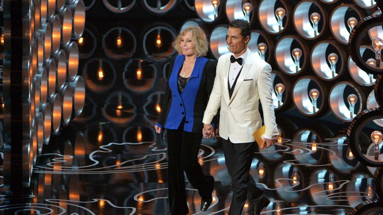Kim Novak, left, and Matthew McConaughey walk on stage at the Oscars