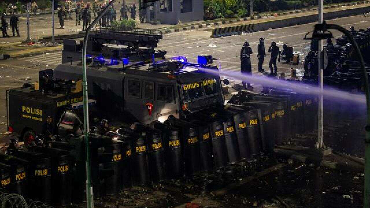 Police disperse protesters with a water cannon in Jakarta, Indonesia May 23, 2019.