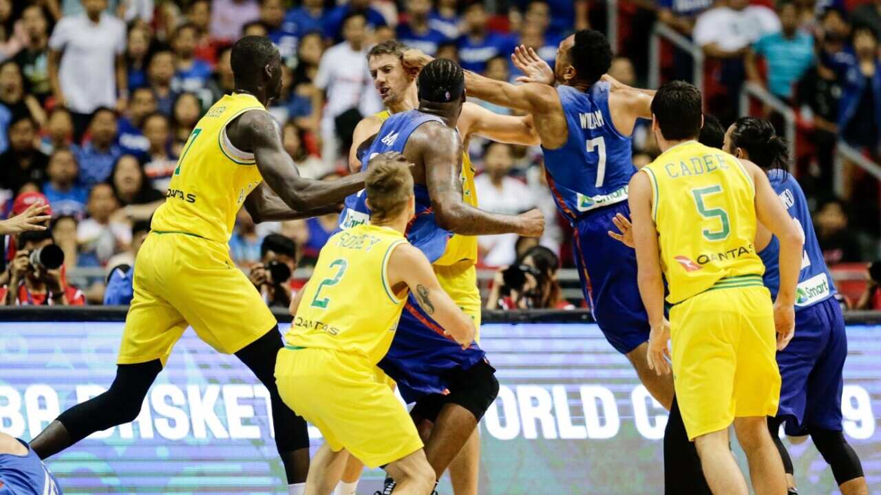 Daniel Kickert (C- back) of Australia in action against Jayson Castro (2-R) of the Philippines
