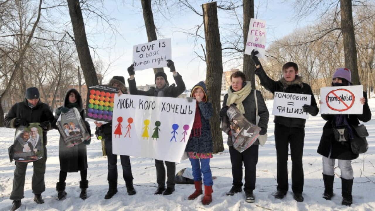 Gay-rights activists hold placards on Fe