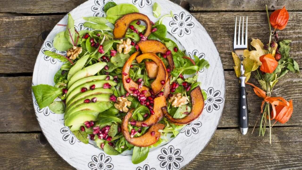 Autumnal salad with squash, pomegranate seeds, avocado and walnuts