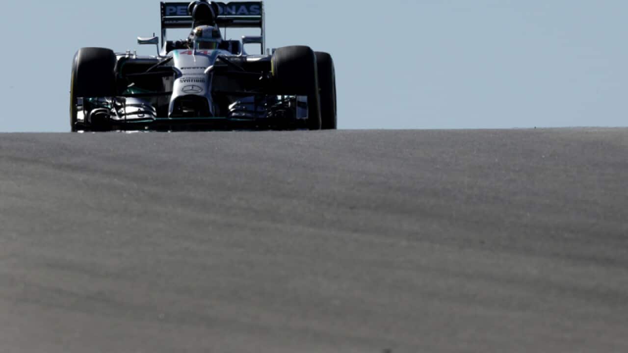 Mercedes driver Lewis Hamilton, of Britain, tops a hill.