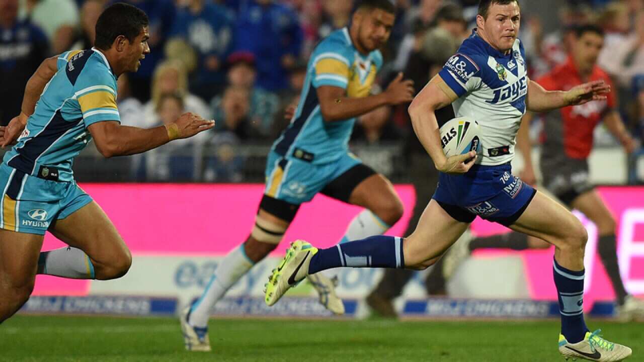 Brett Morris of the Bulldogs makes a break to score a try