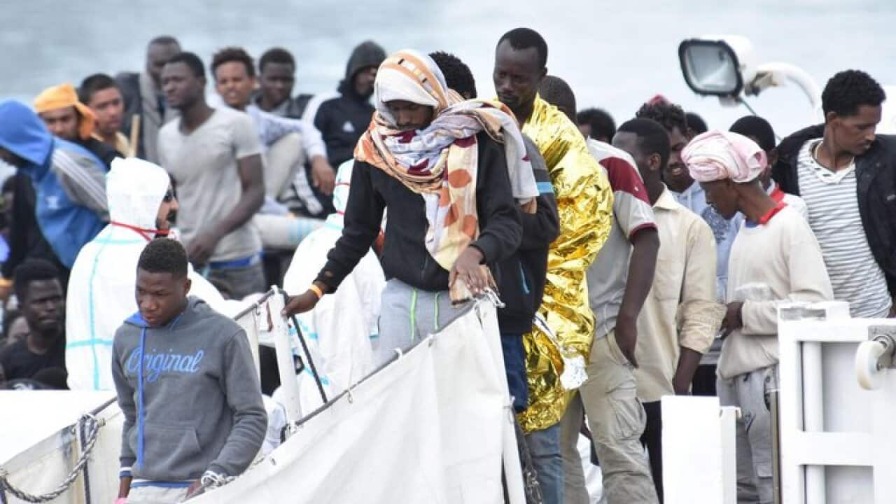 Migrants depart the coast guard ship 'Diciotti' after arriving at Catania Port, Italy, 13 June 2018. According to reports, over 900 migrants were rescued during an operation by the 'Diciotti'. EPA/ORIETTA SCARDINO