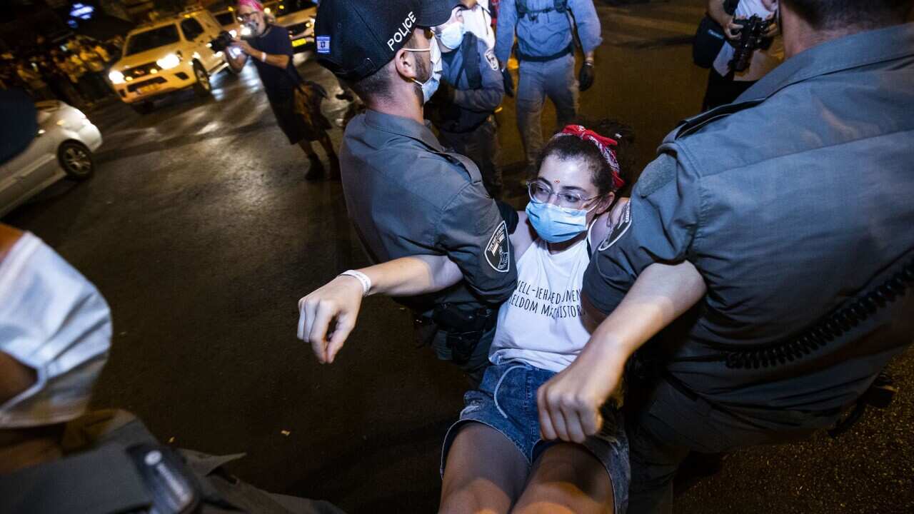 Israeli police arrest a demonstrator during a protest against Israeli Prime Minister Benjamin Netanyahu