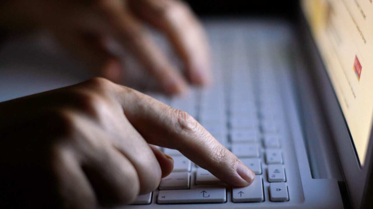 A person using a laptop.