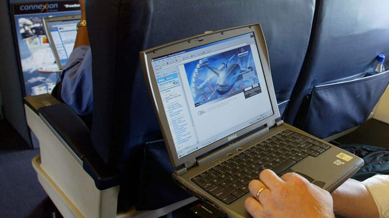 A laptop being used on a plane