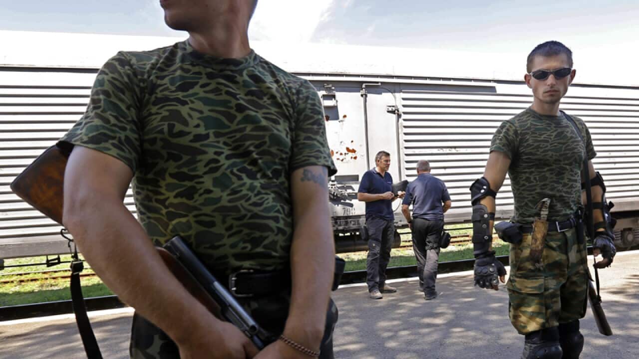 Separatist armed soldiers guard the scene